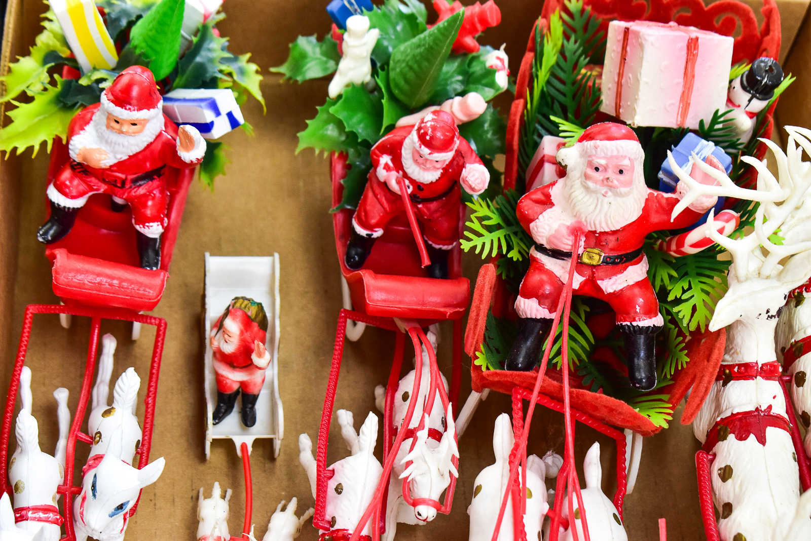 COLLECTION OF TABLE-TOP PLASTIC SANTA WITH SLEIGH & REINDEERS