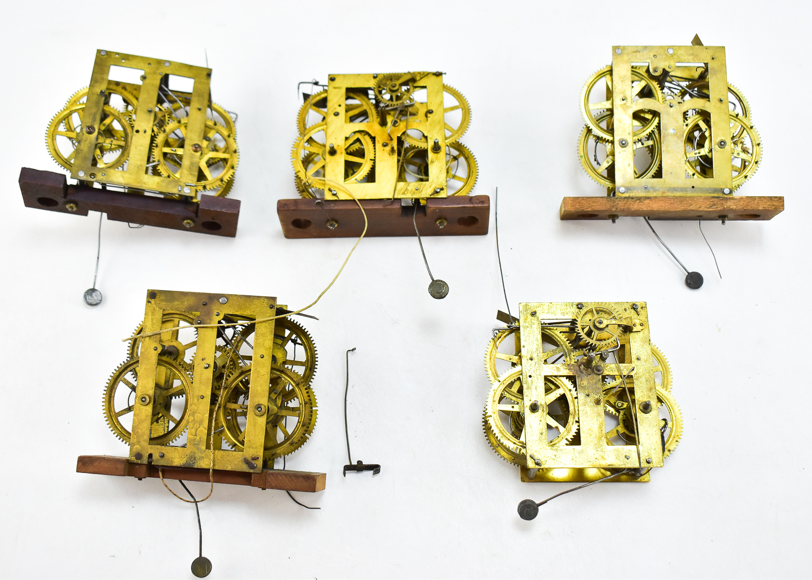 FIVE BRASS CLOCK MOVEMENTS