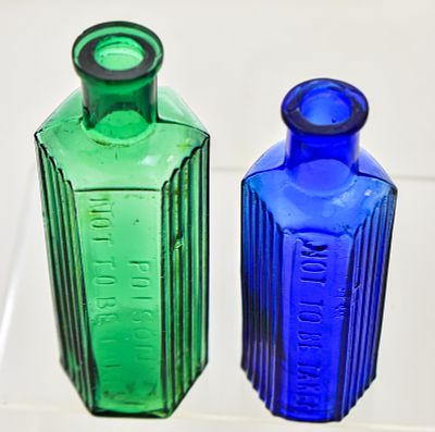 VICTORIAN-ERA COBALT BLUE AND EMERALD GREEN POISON BOTTLES. This lot includes two Victorian-era 