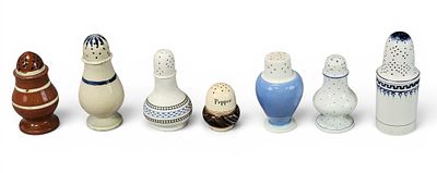 COLLECTION OF PEPPER POTS. English, 19th century. Includes pearlware, redware, engine-turned 