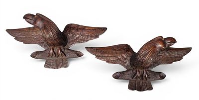 PAIR OF CARVED EAGLES. American, late 19th century, possibly chestnut. Spread-winged eagles 