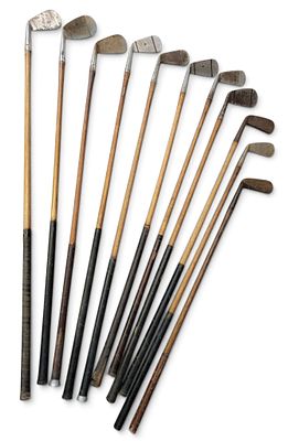 ASSEMBLED SET OF WOOD-SHAFT GOLF CLUBS. Early 20th century. Mixed brands, 11 clubs, in a leather 