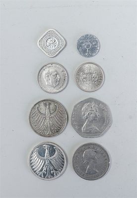 A varied collection of foreign coins, originating from Germany and Spain, among others. This 