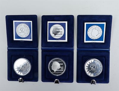 A set of three Dutch silver 50 guilder commemorative coins featuring the likeness of Beatrix. 