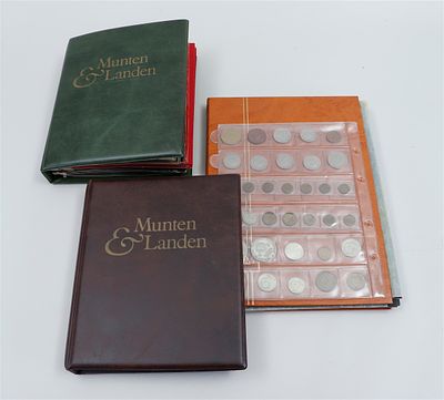An extensive collection of world coins, housed in various folders, including silver coins. 