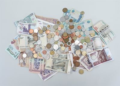 A collection of various foreign currencies in coins and banknotes.