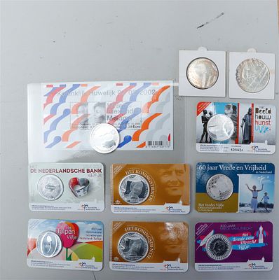 Collection of coin cards and euro coins, including silver specimens.