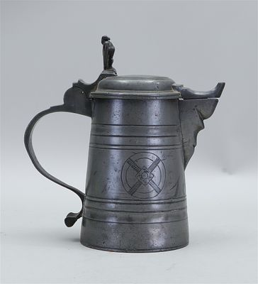 Pewter lidded jug featuring an eagle on the lid, engraved with the letters G.M., decorated with 
