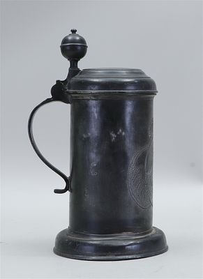 Pewter lidded jug with a family coat of arms on the front. Engraved on the lid D.H. F.R.R. and 