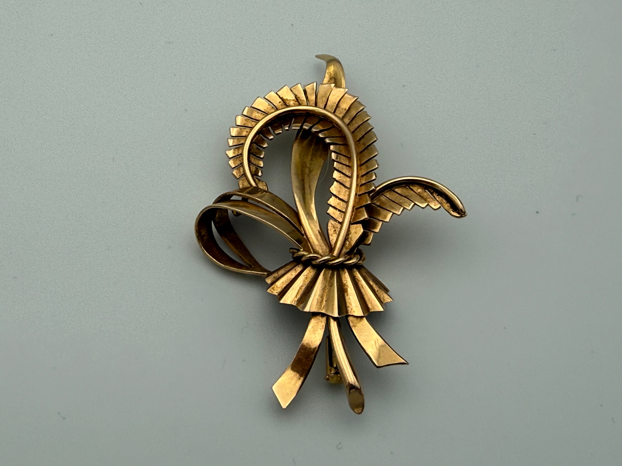 Circa 1950s French Yellow Metal Stylised Fern Leaf And Ribbon Bow Brooch