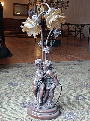 A Late 19th/Early 20th Century Style Spelter Figural Floor Lamp with Art Glass Shades