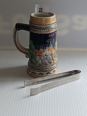 A Glazed Ceramic Souvenir Beer Stein, depicting Karlův Most, Prague, and a Metal Serving Tongs