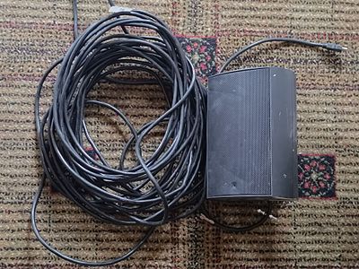 A Modern Black Audio Speaker with Connecting Cable