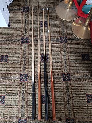 A Set of Four Wooden Billiards Cues