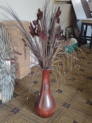 A Tall Artificial Floral Bouquet with Grass and Branch Accents in a Decorative Vase