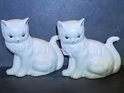 A Pair of Cardia White Ceramic Lounging Cat Figurines