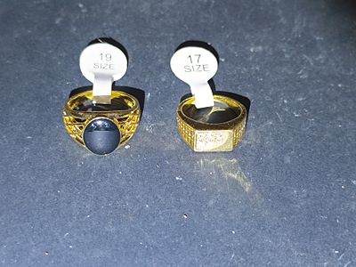 A Pair of Men's Yellow Gold Toned Rings, One with Cubic Zirconia