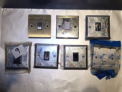 A Group of Contemporary Metallic Electrical Wall Switches, including Eaton
