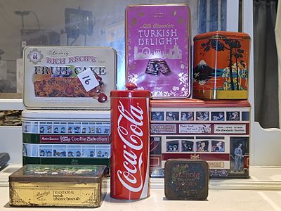 A Coca-Cola Can Bank Tin and a Collection of Six Decorative Metal Tins