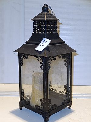 A Decorative Black Metal and Glass Candle Lantern