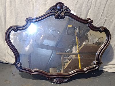 A Rococo Revival Dark-Stained Carved Wood Wall Mirror