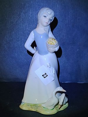 A Tengra Porcelain Figurine of a Girl Feeding Geese