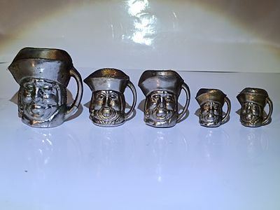 A Graduated Set of Five Vintage Miniature Silver-Colored Metal Toby Jugs