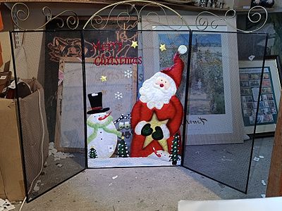 A Festive Three-Panel Folding Metal Christmas Fireplace Screen with Santa and Snowman Decoration
