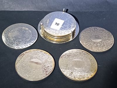 A Set of Engraved Silver-Toned Coasters with Stand