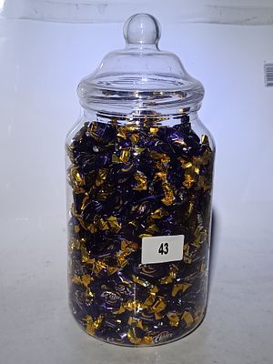 A Glass Storage Jar of Cadbury Chocolate Eclairs
