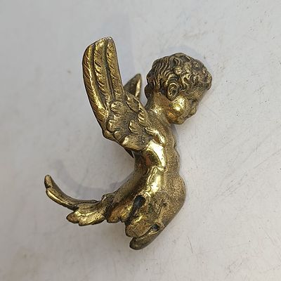 A Brass Winged Putto Decorative Mount