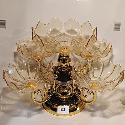 A Contemporary Rotatable Multi-Tiered Gilt-Metal and Amber Glass Serving Centerpiece