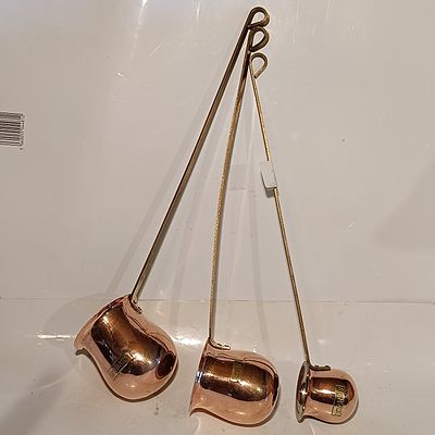 A Trio of Graduated Copper and Brass Spirit Measures