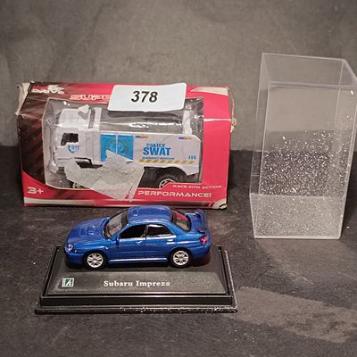 A Pair of Toy Vehicles Including Hongwell Subaru Impreza and Hy-Drive MAN L90 Police SWAT Truck