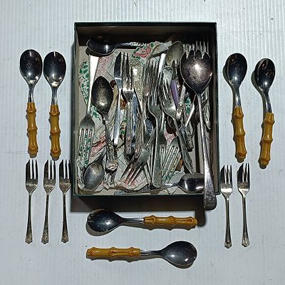 An Assortment of Miscellaneous Flatware and Serving Pieces Including Faux Bamboo Style Spoons