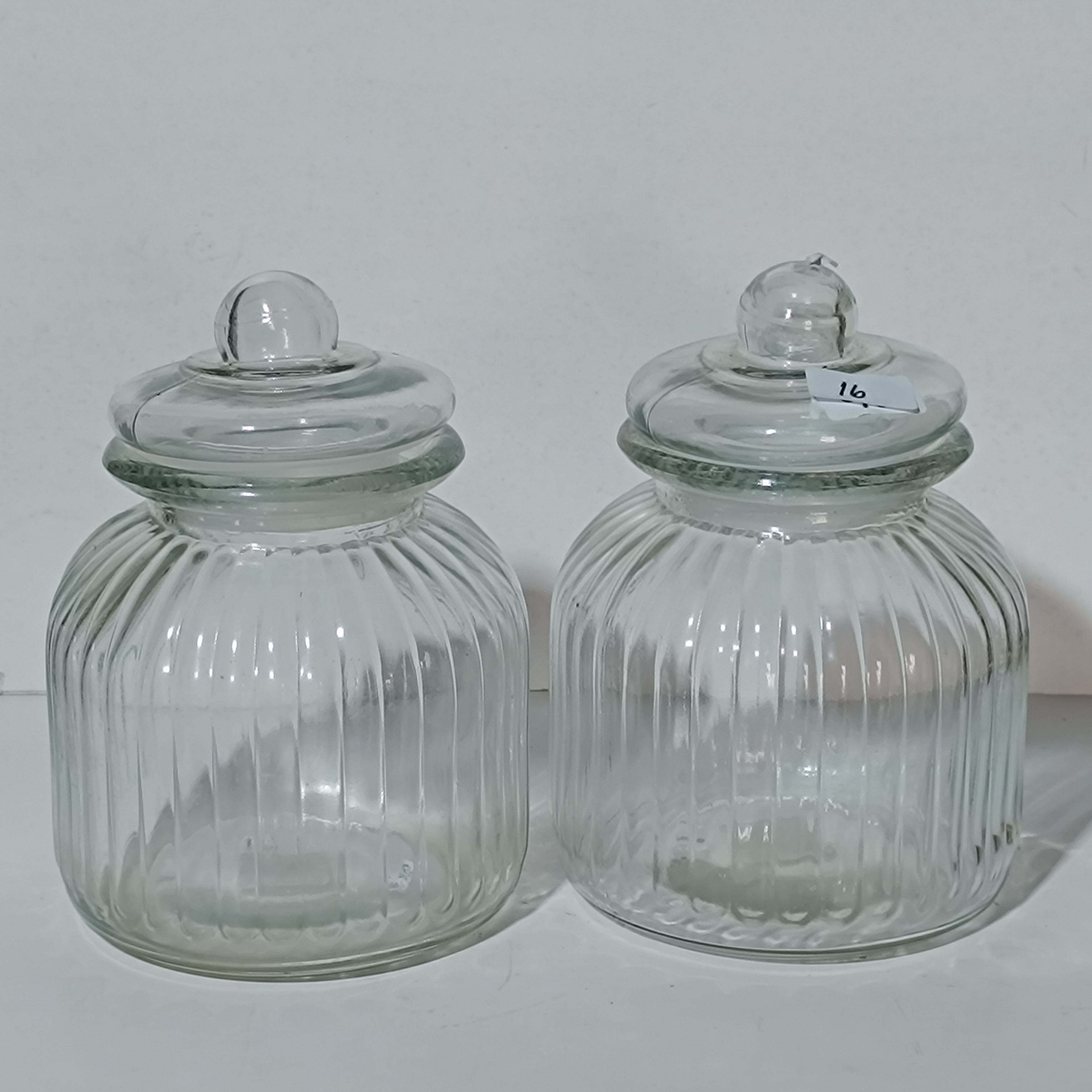 A Pair of Ribbed Clear Glass Apothecary Storage Jars with Domed Lids