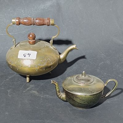 Two Decorative Metal Teapots Including a Footed Engraved Brass Kettle