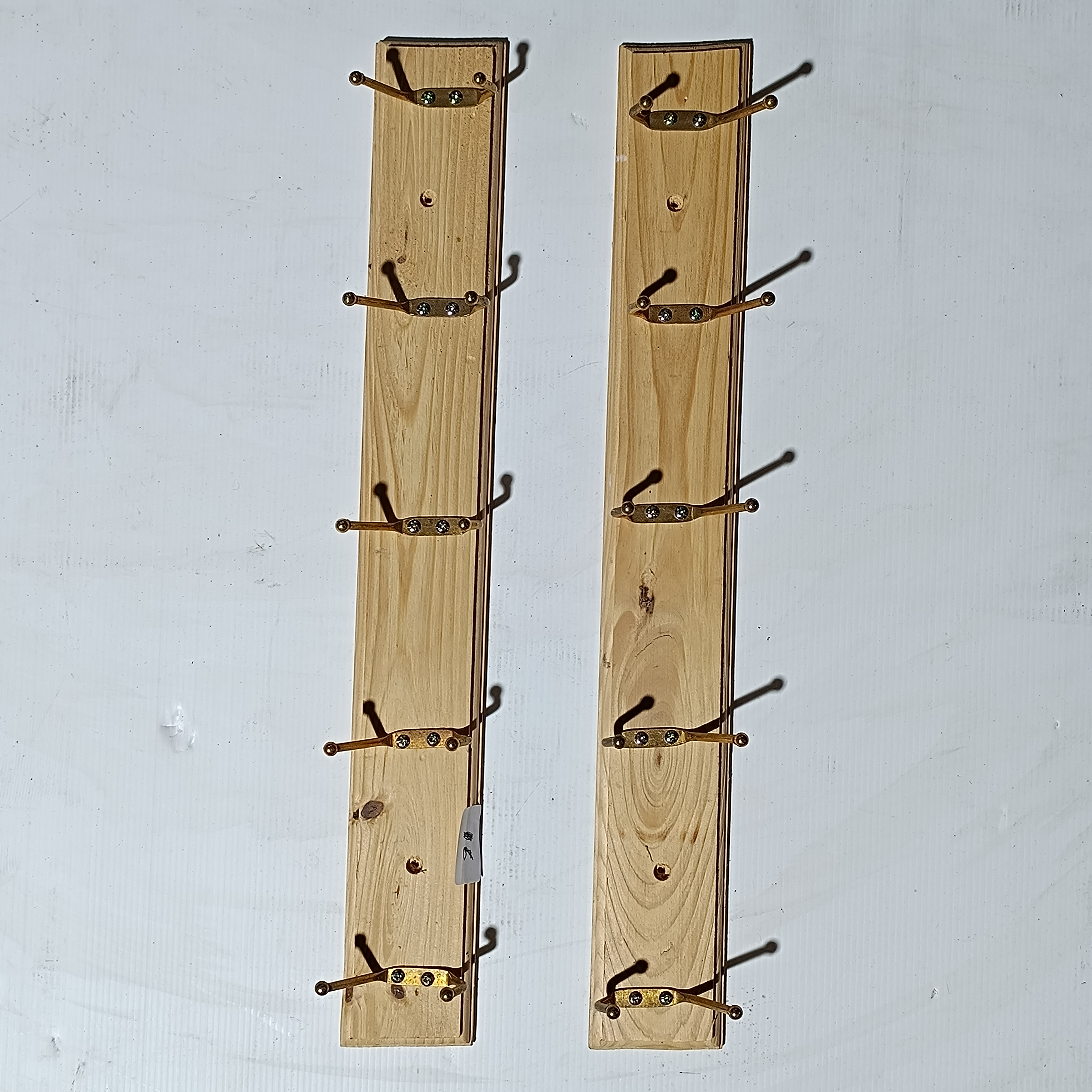 A Pair of Wall-Mounted Pine Wood Coat Racks with Ten Double Hooks