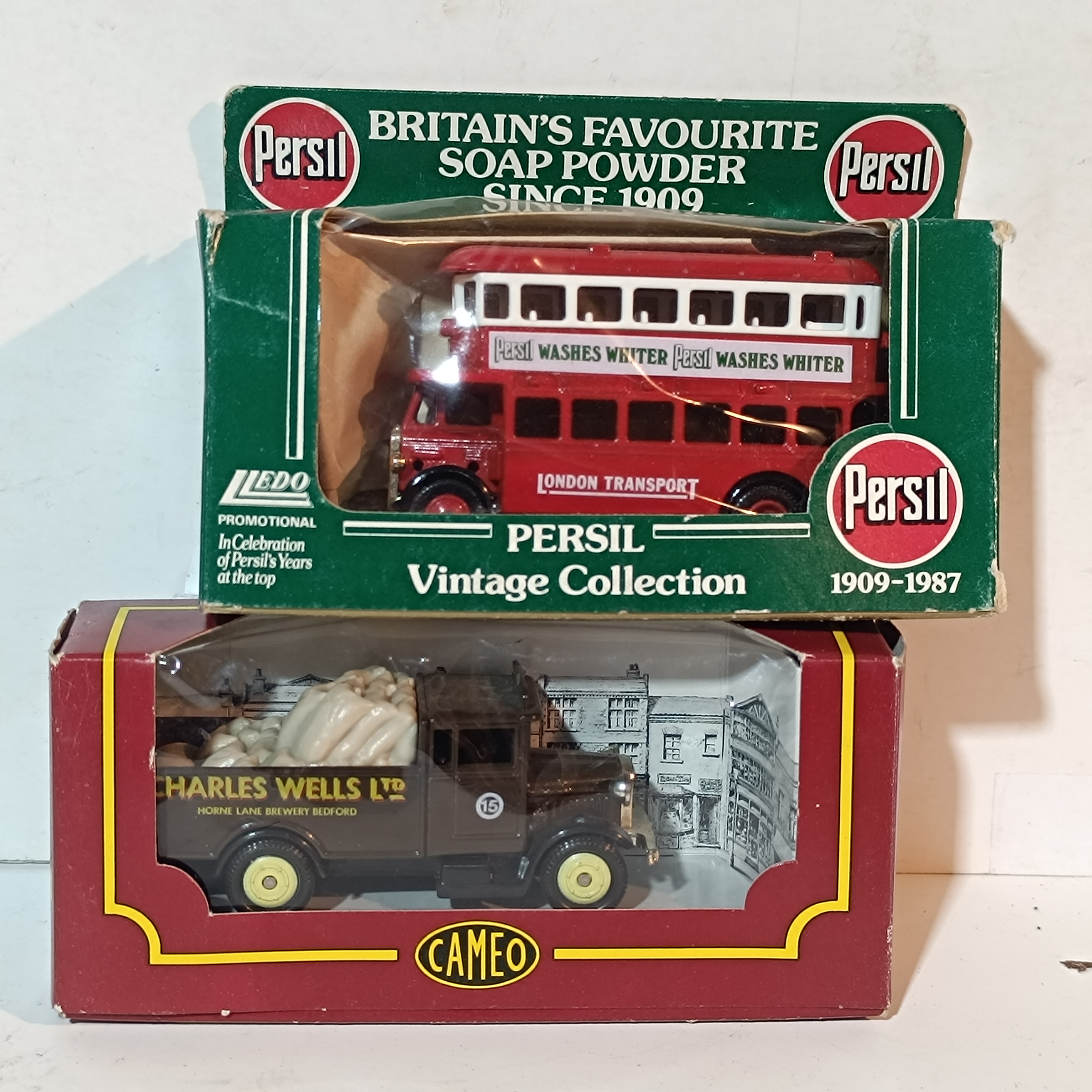 A Pair of Die-Cast Promotional Vehicles Including Lledo Persil Bus and Cameo Charles Wells Ltd Truck