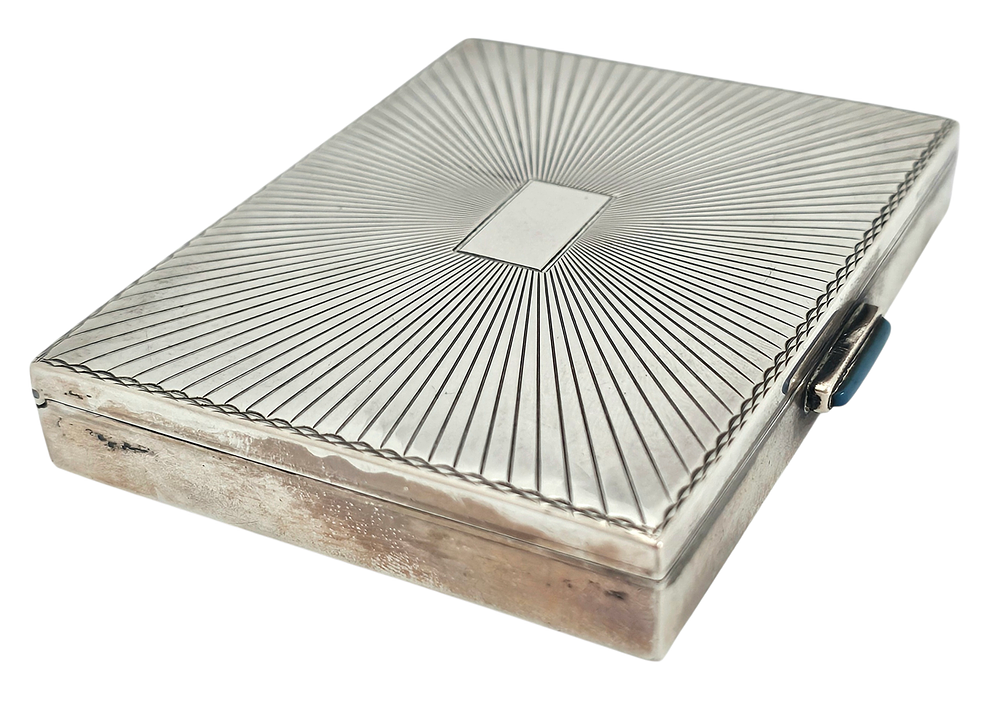 Art Deco silver cigarette case with geometric design and a place at center for a monogram. 