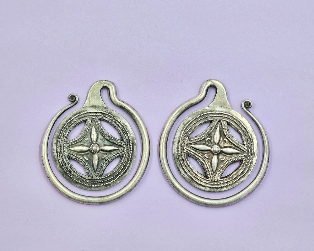 Tribal Tibetan Chinese earrings made of white metal with embossed details. 
10cm diameter x 