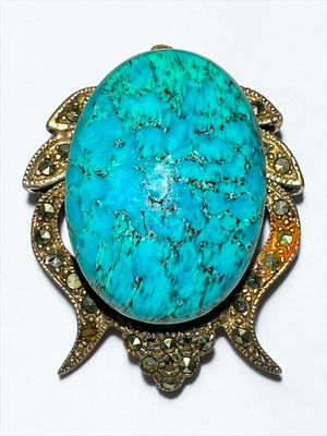 Turquoise Stone Brooch. Brooch with large turquoise stone in center and gold-tone metal frame 