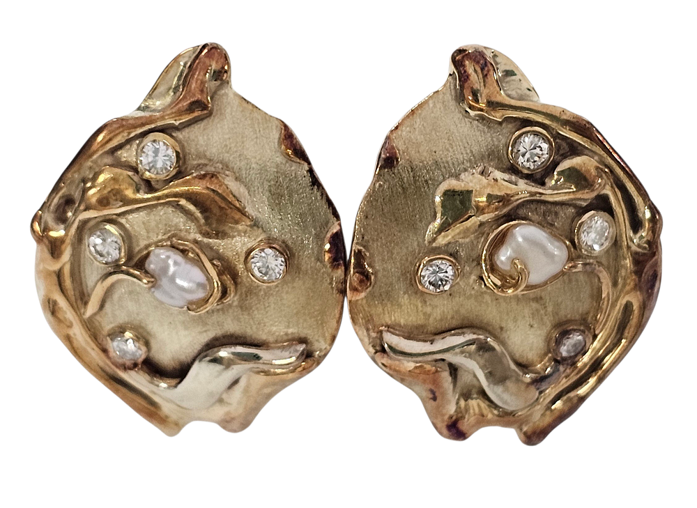 A pair of hand made artistic post earring made out of 18k gold, embellished with pearl and 