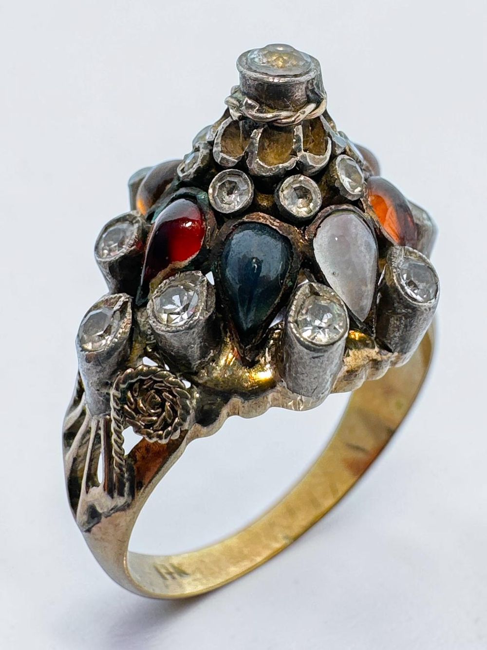 14k gold ring, "crowned" in silver at top, set with zircons and various colorful stones. 