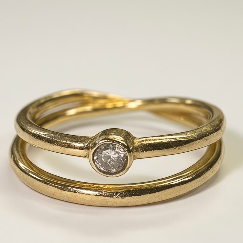 14k gold ring, with small diamond (2 pts) at center. Gold band is "wrapped", looking like two 