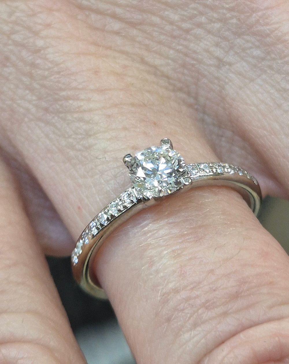 Diamond engagement ring: 
18k white gold set with one center solitaire stone 64 points and 