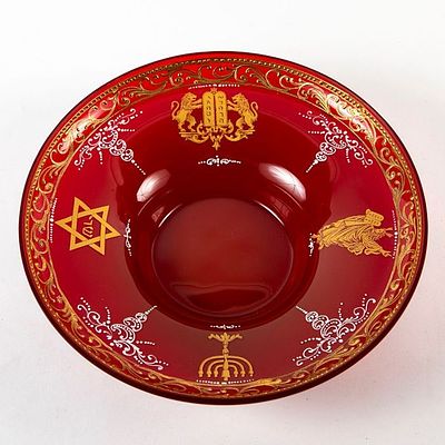 A hand blown bohemian glass vessel in a toffee-red hue, decorated with gold and enamel 