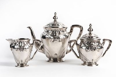 German Art Nouveau silverware set, circa 1900, three pieces including: a teapot, a sugar bowl 