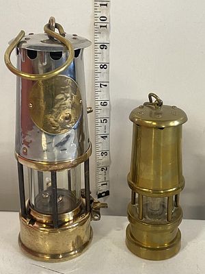 A vintage miner's lamp and one smaller