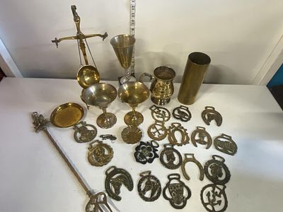 A job lot of assorted brass items including horse brasses, shipping unavailable